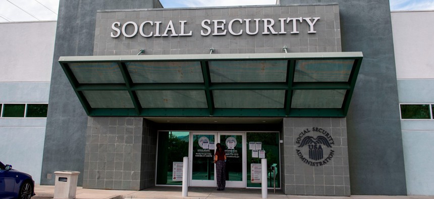 A woman stands outside a US Social Security Administration building, November 5, 2020, in Burbank, Calif.