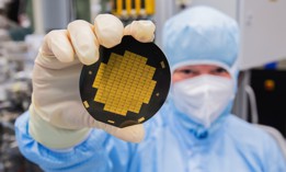 A research associate shows microchips for quantum processors in a clean room laboratory at the Physikalisch-Technische Bundesanstalt PTB in Braunschweig, Germany.