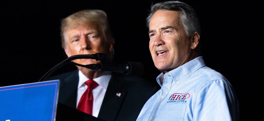 Rep. Jody Hice (R-Ga.) appears with former President Donald Trump in a September 2021 campaign rally in Perry, Georgia. Hice introduced legislation to restore Trump's overturned executive order making it easier to fire thousands of federal employees.