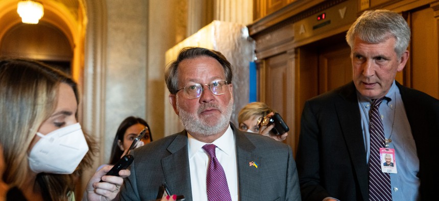 Sen. Gary Peters  speaks with reporters as he leaves the Senate Democrats weekly lunch in the Capitol on May 24, 2022.