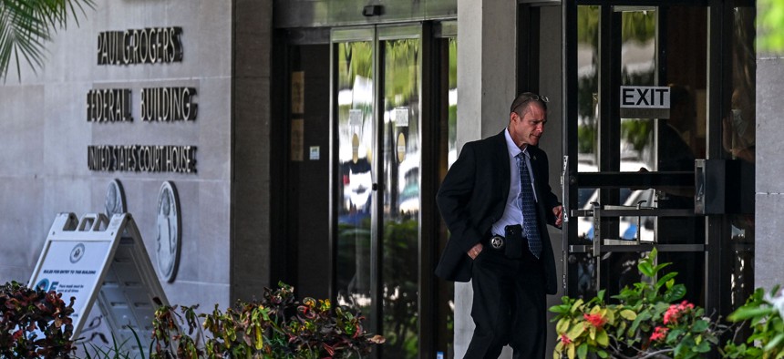 Security officers guard the entrance to the Paul G. Rogers Federal Building & Courthouse as the court holds a hearing to determine if the affidavit used by the FBI as justification for last week's search of Trump's Mar-a-Lago estate should be unsealed, at the US District Courthouse for the Southern District of Florida in West Palm Beach, Florida on August 18, 2022. - FBI agents recovered multiple highly classified records during the search of former US President's estate, according to documents made public during a probe that includes possible violations of the US Espionage Act.