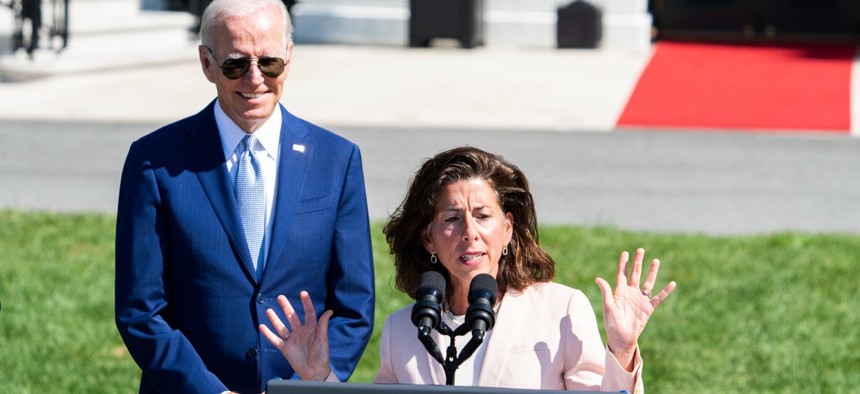 Secretary of Commerce Gina Raimondo speaks as President Joe Biden looks on, during The CHIPS and Science Act of 2022 bill signing on August 9, 2022.