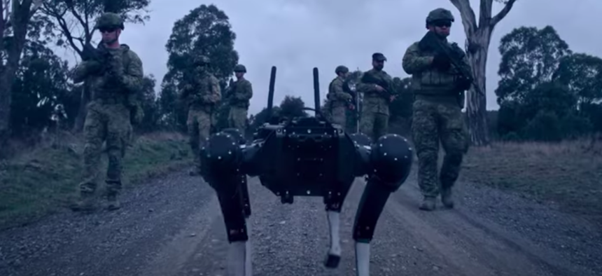 A Ghost Robotics ground robot accompanies a group of soldiers on a demonstration of robot piloting via brain signal