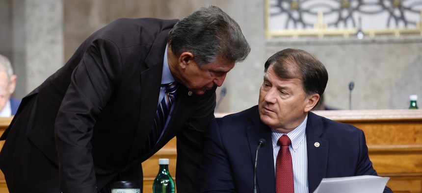 Senate Armed Services Committee members Joe Manchin (D-W.V.) and Mike Rounds (R-S.D.) pushed back on the idea of pausing AI development during a subcommittee hearing on cybersecurity Wednesday and called for congressional action to update policies.