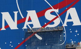 Workers repaint the NASA logo on the Vehicle Assembly Building at the Kennedy Space Center.